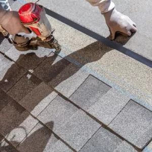 A roofer installing new roofing materials, demonstrating the roof replacement process.