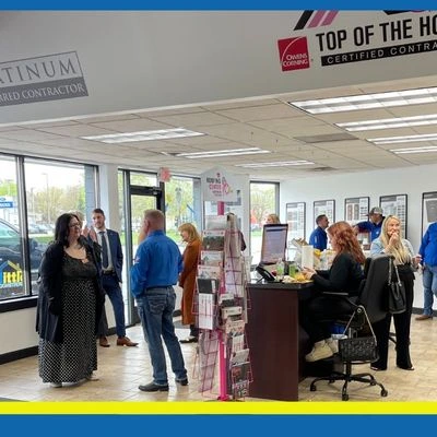roofing-showroom-customers Interior of Tittle Brothers Construction showroom with customers browsing roofing products and displays.