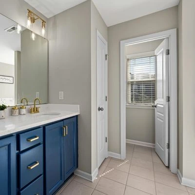 blue-vanity-modern-bathroom (1) Modern bathroom with blue vanity, gold hardware, and neutral walls
