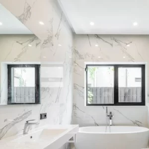 luxury-bathroom-marble-walls (1) Luxury bathroom with marble walls, freestanding tub, and large window